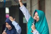 PICTURED: Community members and children take part in activities to raise awareness about girls' rights and child marriage run by the Yes I Do Alliance in Lombok, Indonesia.